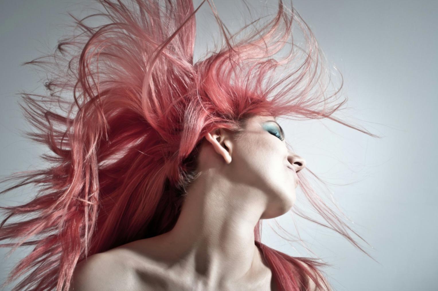 Students practicing advanced styling techniques with individual guidance